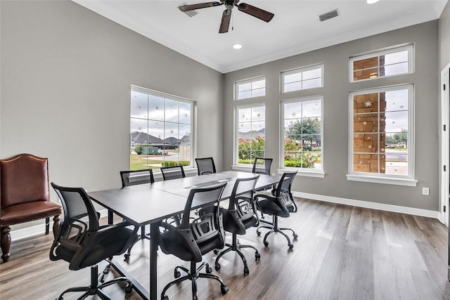 office featuring ceiling fan, crown molding, a healthy amount of sunlight, and light wood-type flooring