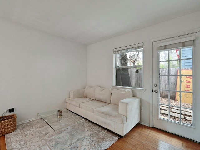 living room with light wood-type flooring and baseboards