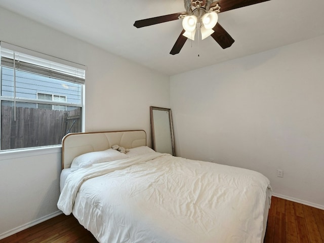 bedroom featuring ceiling fan and dark wood-type flooring