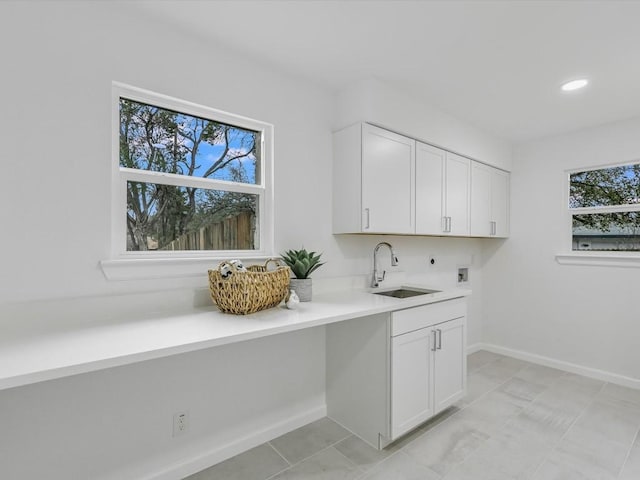 laundry room featuring sink, cabinets, washer hookup, electric dryer hookup, and light tile patterned flooring