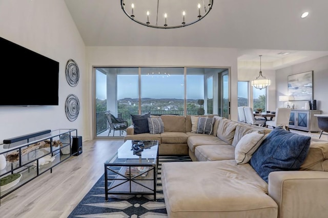 living room featuring a mountain view, light hardwood / wood-style flooring, and a notable chandelier