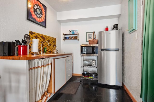 kitchen featuring wooden counters and appliances with stainless steel finishes