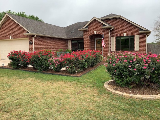 ranch-style house with a garage, brick siding, a front lawn, and a shingled roof