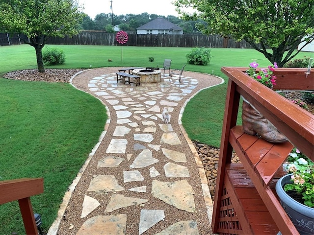 surrounding community with a fire pit, a yard, fence, and a patio