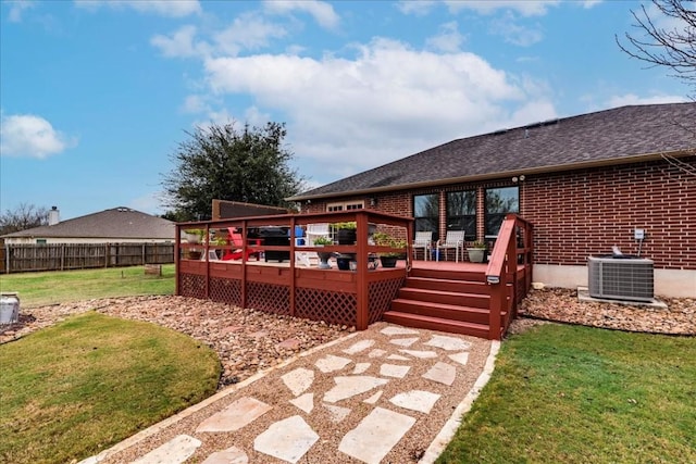 wooden terrace with central AC, fence, and a lawn