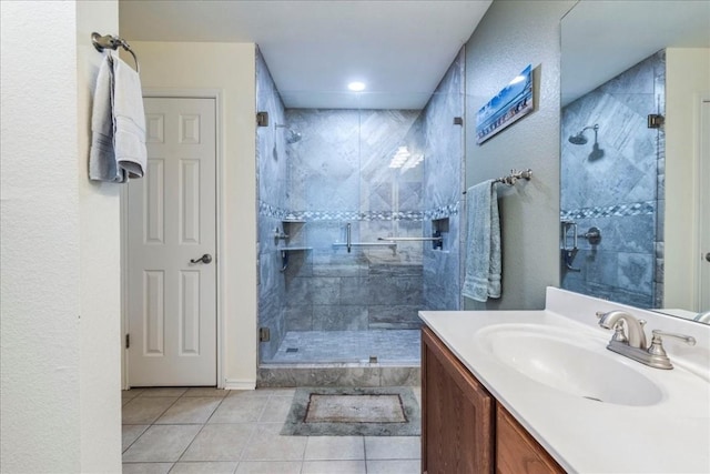 bathroom with a stall shower, vanity, and tile patterned floors