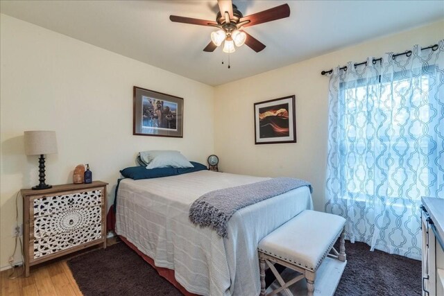 bedroom with a ceiling fan and wood finished floors