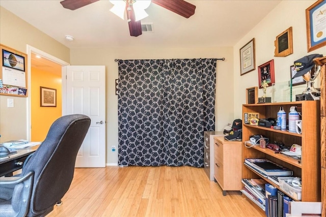 office space with light wood-style flooring, visible vents, and ceiling fan