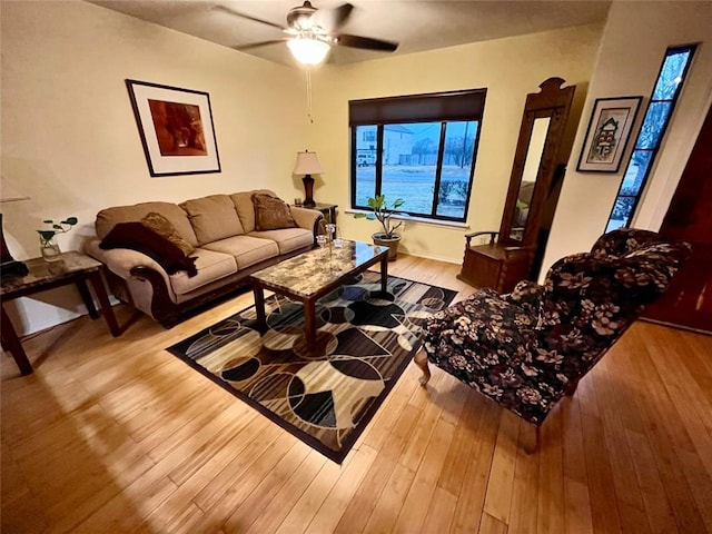 living area with ceiling fan and hardwood / wood-style floors