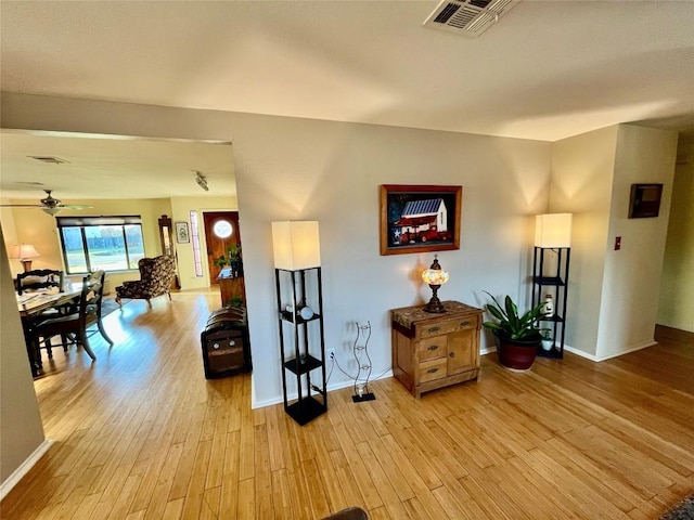 interior space featuring light wood-style flooring, visible vents, and baseboards