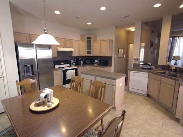 kitchen featuring sink, hanging light fixtures, white appliances, and light brown cabinets