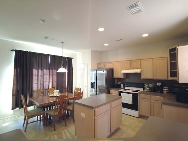 kitchen featuring light brown cabinetry, stainless steel fridge, pendant lighting, a center island, and white range with electric cooktop