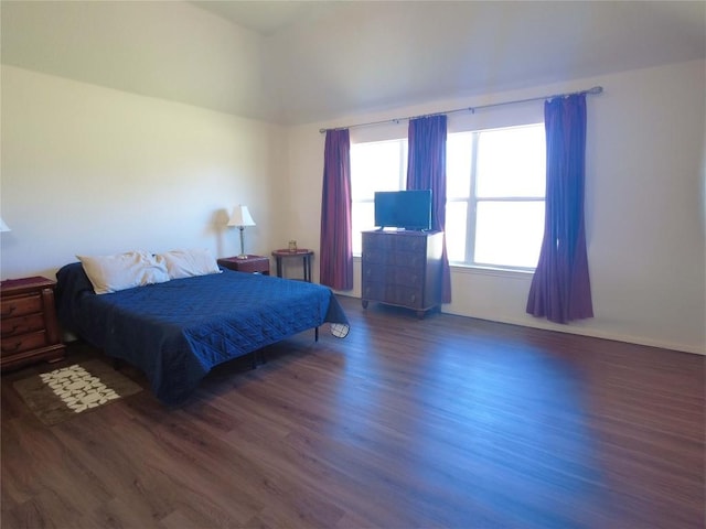 bedroom with dark wood-type flooring