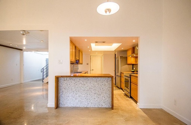 kitchen featuring wall chimney range hood, kitchen peninsula, stainless steel electric range oven, and sink