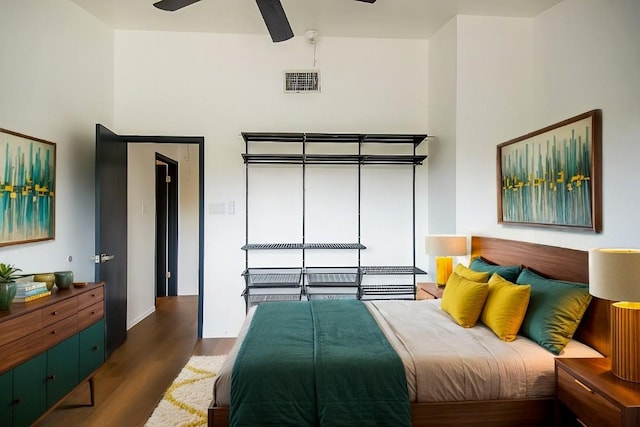 bedroom featuring ceiling fan and dark wood-type flooring