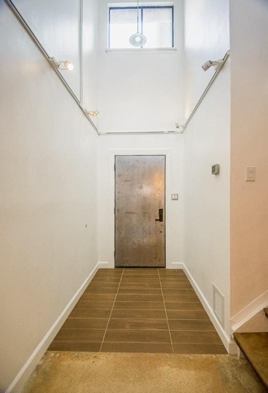 doorway to outside featuring tile patterned flooring