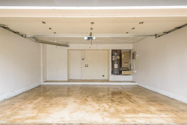 garage featuring a garage door opener and water heater