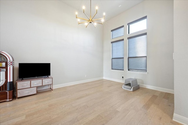 interior space featuring light wood-type flooring and a notable chandelier