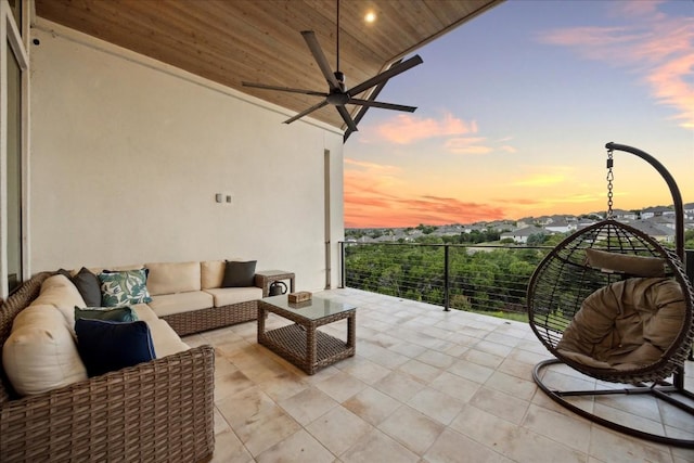 balcony at dusk featuring an outdoor living space