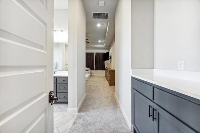 hallway with light colored carpet