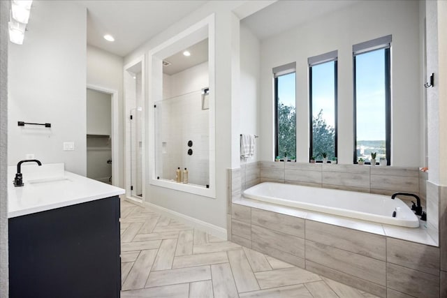 bathroom with vanity and independent shower and bath