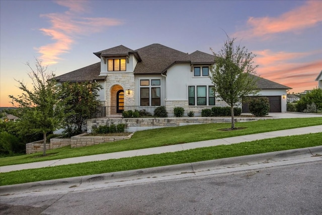 view of front of house with a lawn and a garage