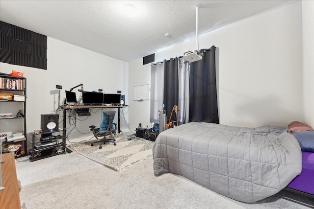 bedroom with carpet floors and a textured ceiling