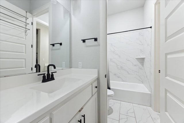 full bathroom featuring vanity, tiled shower / bath combo, and toilet