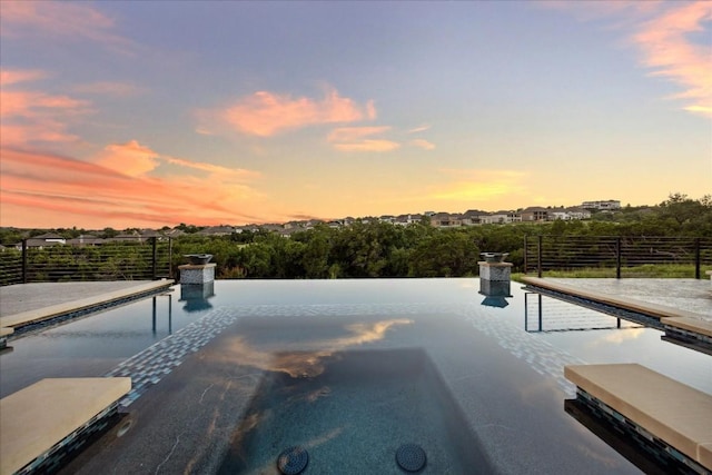 view of pool at dusk