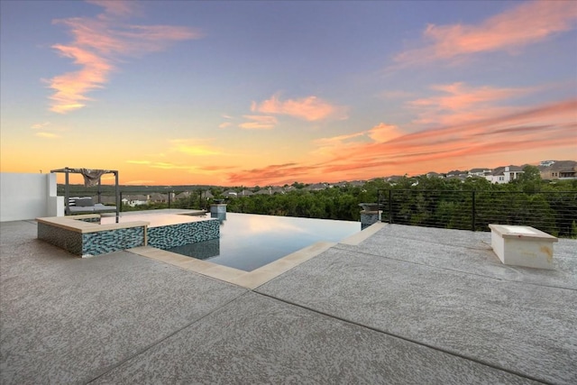 pool at dusk with a patio