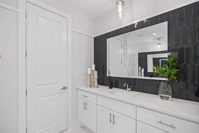 bathroom featuring vanity and backsplash