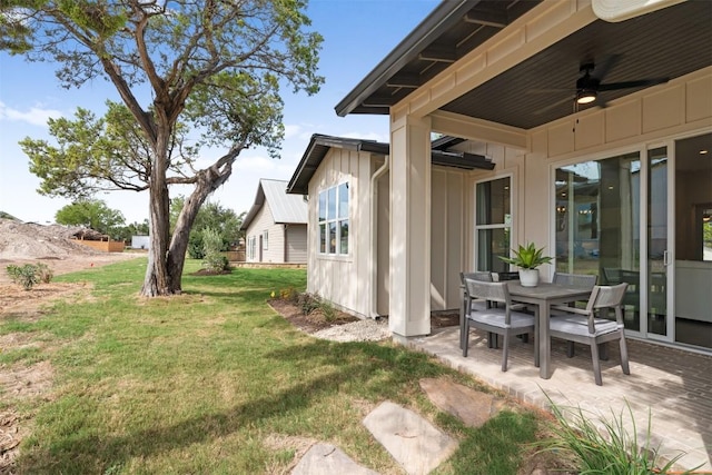 view of yard with ceiling fan and a patio area