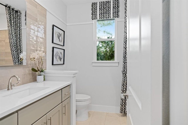 bathroom featuring tile patterned flooring, a healthy amount of sunlight, toilet, and backsplash