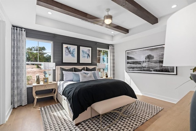 bedroom with ceiling fan, light hardwood / wood-style flooring, and multiple windows