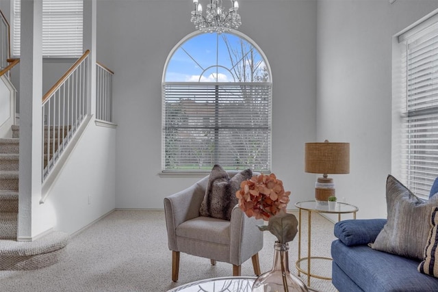 sitting room featuring carpet flooring and an inviting chandelier