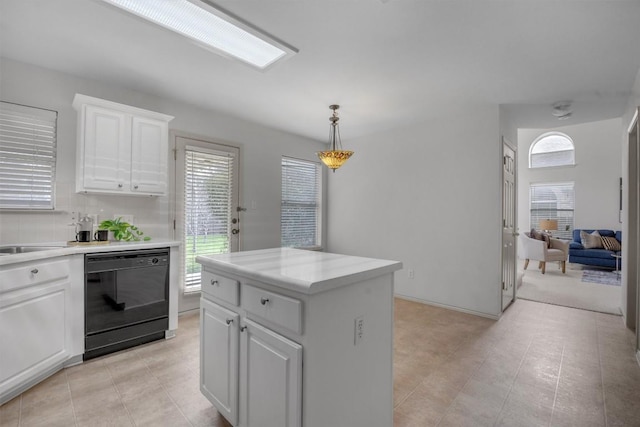 kitchen with tasteful backsplash, a kitchen island, dishwasher, white cabinetry, and hanging light fixtures