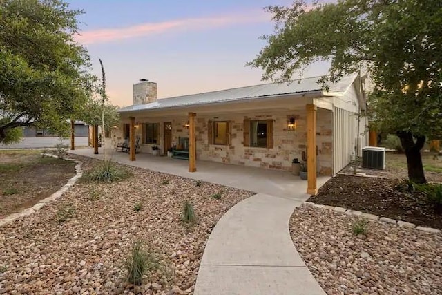 exterior space with central air condition unit and a patio area