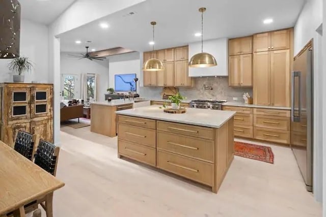 kitchen featuring a center island, light brown cabinets, kitchen peninsula, pendant lighting, and decorative backsplash