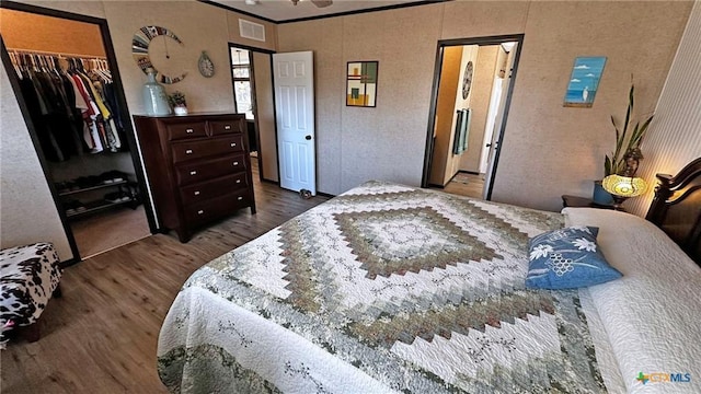 bedroom featuring dark hardwood / wood-style floors, a closet, and a spacious closet