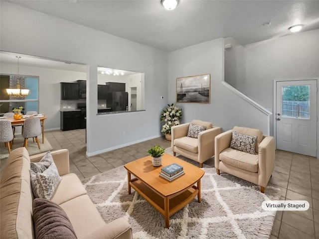 living room featuring a notable chandelier and light tile patterned floors