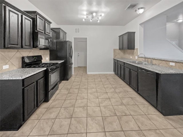 kitchen with black appliances, tasteful backsplash, sink, and an inviting chandelier