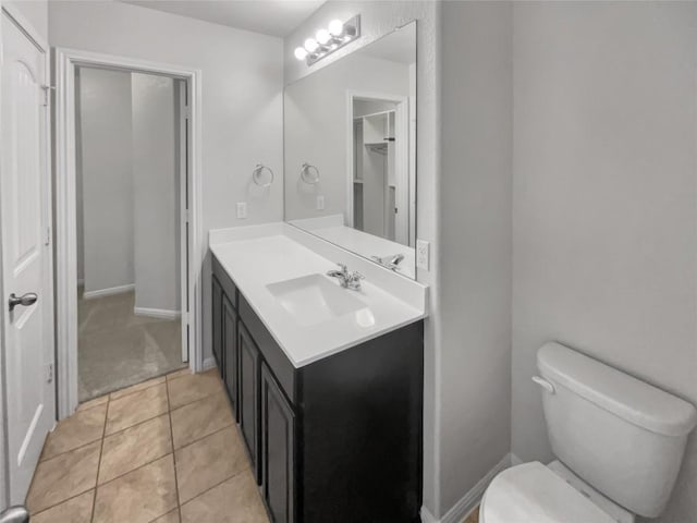 bathroom featuring toilet, vanity, and tile patterned floors