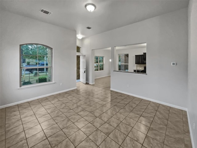 unfurnished living room featuring light tile patterned floors