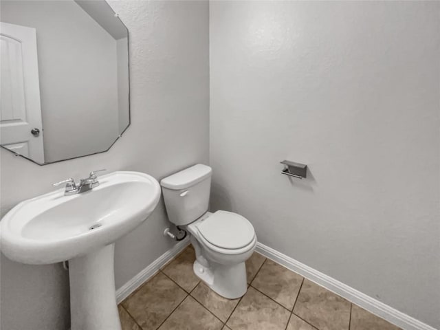 bathroom with tile patterned flooring and toilet