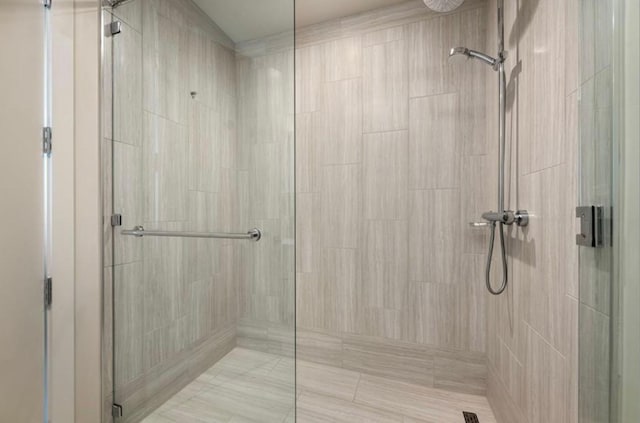 bathroom featuring a shower with shower door