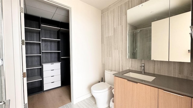 bathroom with hardwood / wood-style floors, vanity, and toilet