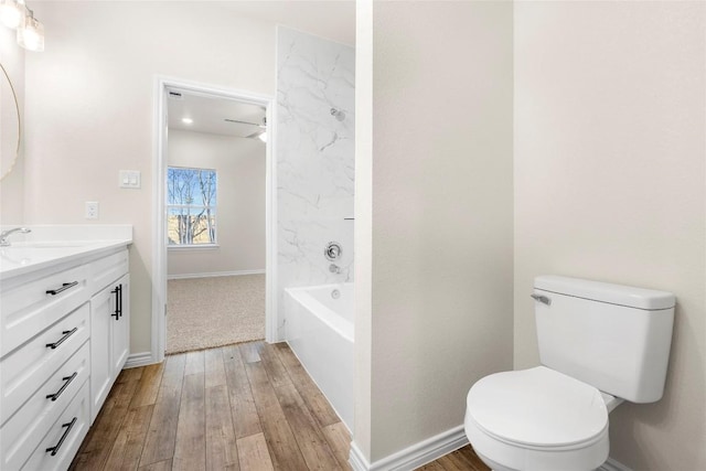 bathroom with hardwood / wood-style flooring, vanity, and toilet