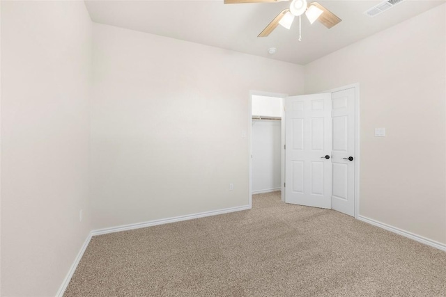 unfurnished bedroom featuring ceiling fan, a closet, and carpet floors