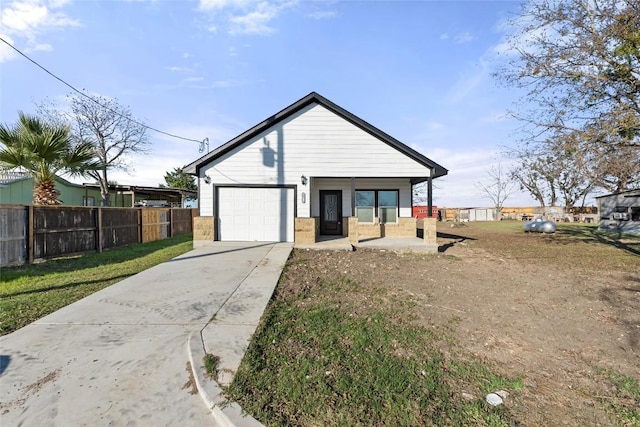 view of front facade with a front lawn, covered porch, and a garage