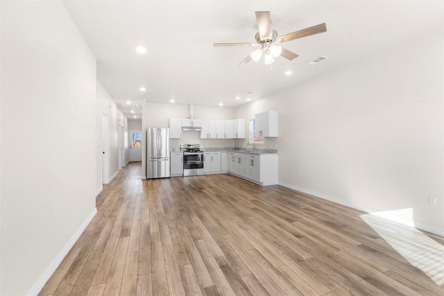 kitchen with white cabinets, sink, light wood-type flooring, and stainless steel appliances